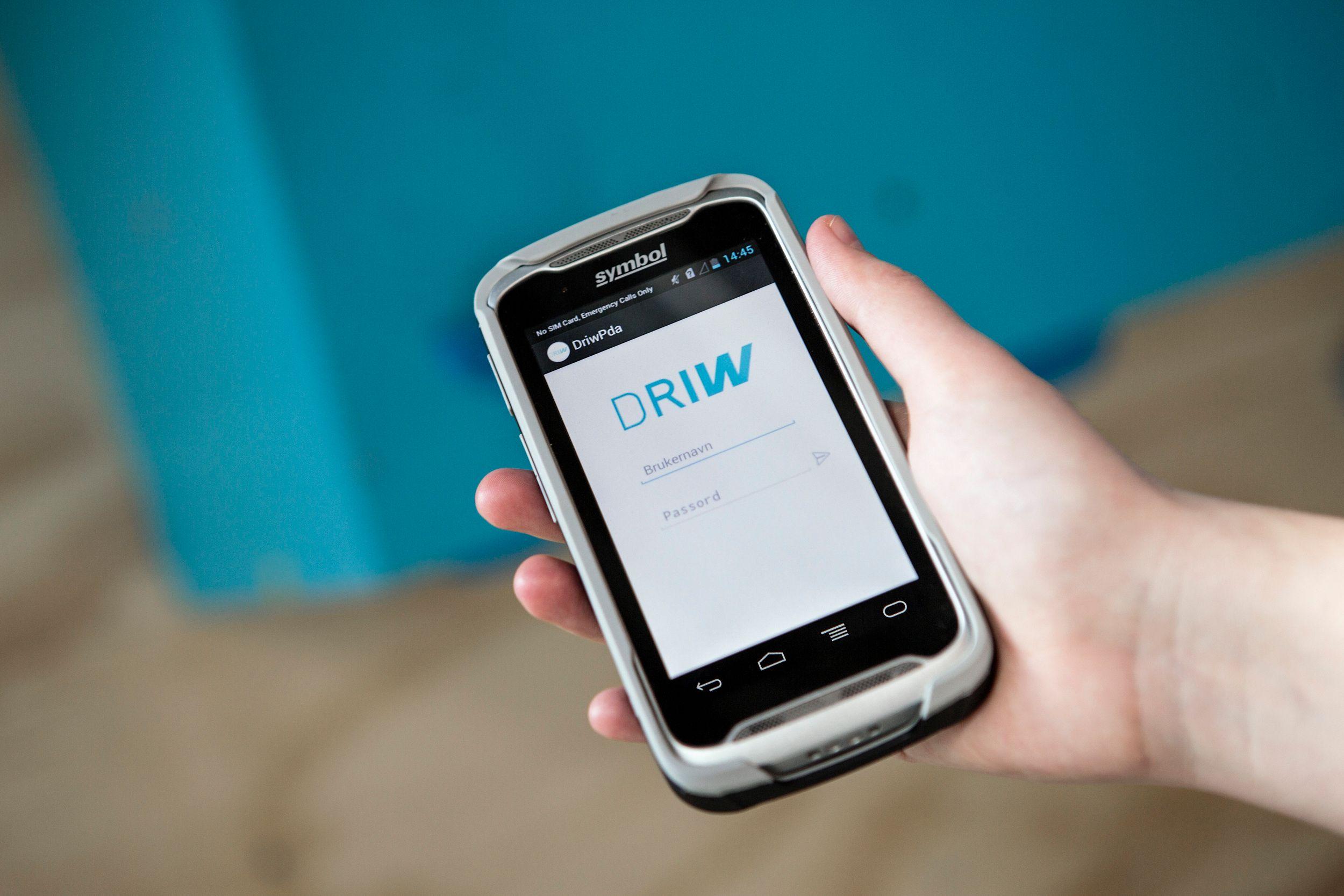A hand holding a mobile device displaying Solwr's software solution